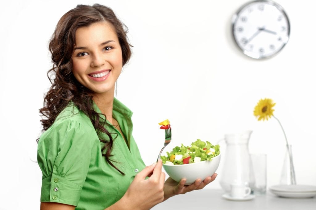 teenage girl eating salad
