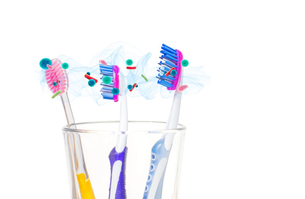 multiple toothbrushes in same cup with airborne bacteria