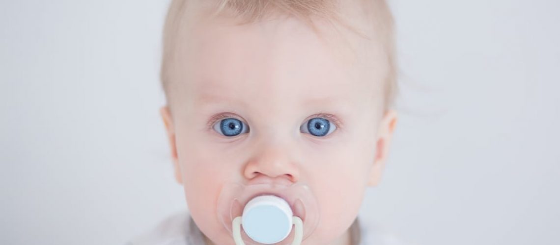 toddler with a pacifier in his mouth
